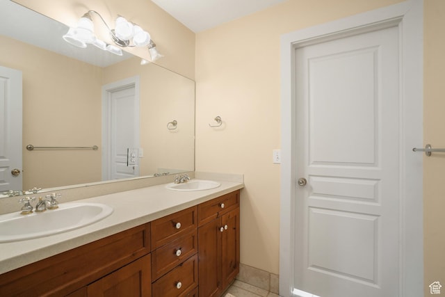full bathroom with double vanity, tile patterned flooring, and a sink