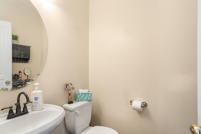 bathroom featuring toilet and a sink
