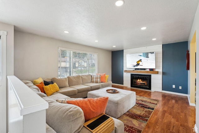 1567 Heather Dr, Layton, UT 84040 - living room with recessed lighting, baseboards, a textured ceiling, a large fireplace, and wood finished floors