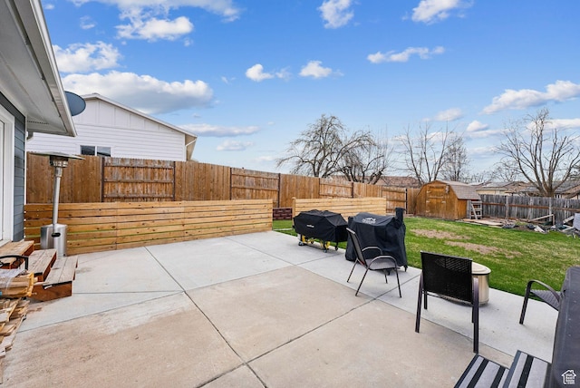 1567 Heather Dr, Layton, UT 84040 - view of patio / terrace with area for grilling, a fenced backyard, an outbuilding, and a storage shed