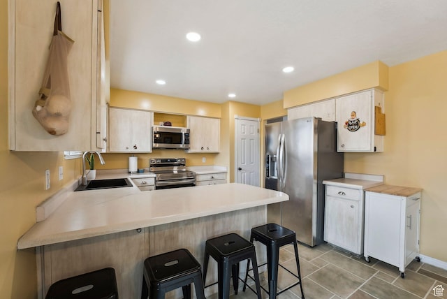1567 Heather Dr, Layton, UT 84040 - kitchen featuring light countertops, a sink, stainless steel appliances, and a peninsula