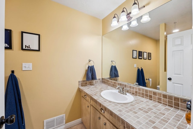 1567 Heather Dr, Layton, UT 84040 - bathroom with vanity, tasteful backsplash, toilet, baseboards, and visible vents