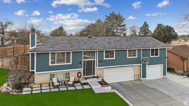 1567 Heather Dr, Layton, UT 84040 - raised ranch featuring fence, an attached garage, a chimney, concrete driveway, and a front yard