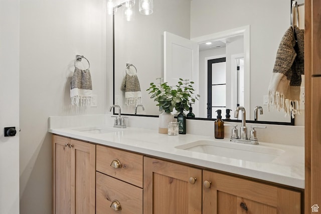 full bath with double vanity and a sink