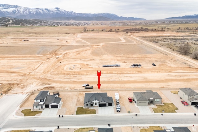 birds eye view of property with a mountain view