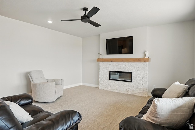 living room featuring carpet flooring, baseboards, ceiling fan, a fireplace, and recessed lighting