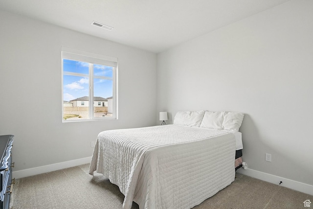 carpeted bedroom with baseboards and visible vents