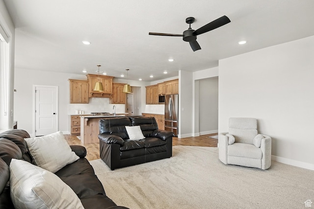 living room with baseboards, ceiling fan, and recessed lighting