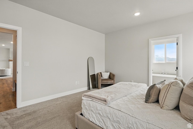 carpeted bedroom featuring baseboards and recessed lighting