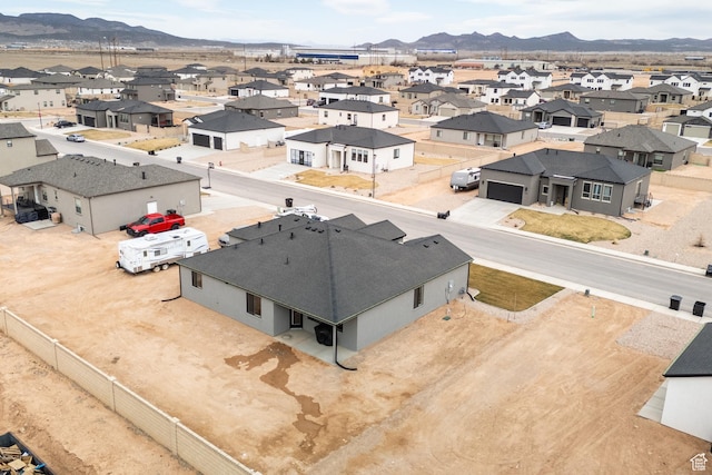drone / aerial view featuring a residential view and a mountain view