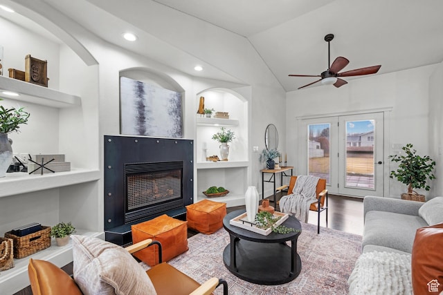 682 N 700 E, Lehi, UT 84043 - living room featuring wood finished floors, a ceiling fan, built in features, a glass covered fireplace, and vaulted ceiling