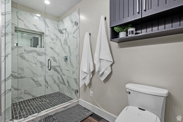 682 N 700 E, Lehi, UT 84043 - bathroom featuring baseboards, toilet, wood finished floors, and a marble finish shower