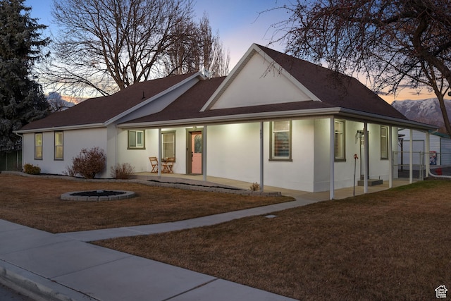682 N 700 E, Lehi, UT 84043 - view of front of home featuring an outdoor fire pit, a front yard, stucco siding, and a patio
