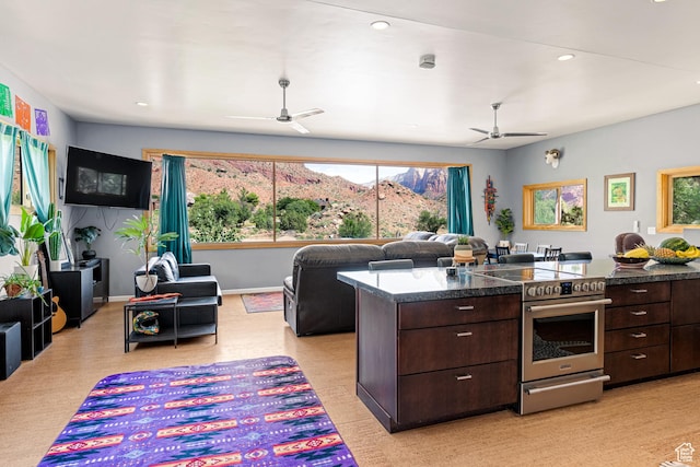 35 Lion Blvd, Springdale, UT 84767 - kitchen featuring open floor plan, stainless steel electric range oven, dark brown cabinets, and ceiling fan