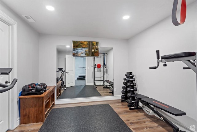 workout area featuring visible vents, wood finished floors, and recessed lighting