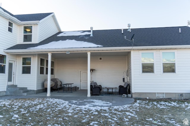 1009 E High Creek Rd, Cove, UT 84320 - snow covered back of property featuring entry steps, a patio, and a shingled roof