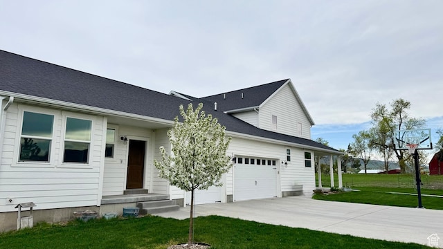 1009 E High Creek Rd, Cove, UT 84320 - view of front of property featuring concrete driveway, a front lawn, and an attached garage