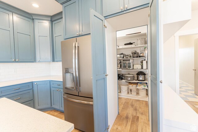 1009 E High Creek Rd, Cove, UT 84320 - kitchen with stainless steel fridge, light wood finished floors, light countertops, backsplash, and recessed lighting