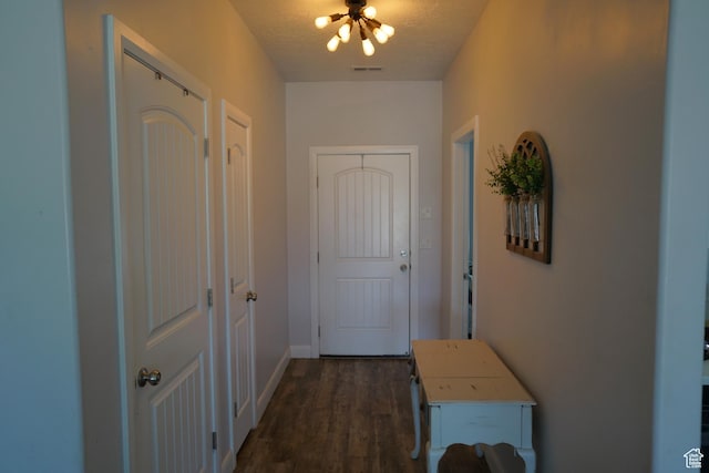160 S 550 E Unit 18, Enterprise, UT 84725 - doorway with a notable chandelier, a textured ceiling, baseboards, visible vents, and dark wood-type flooring