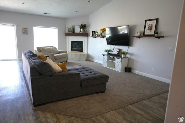 160 S 550 E Unit 18, Enterprise, UT 84725 - living area with baseboards, visible vents, a glass covered fireplace, and wood finished floors