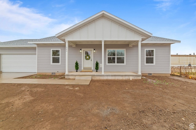 245 E Tidwell Ave Unit 5, Green River, UT 84525 - view of front facade featuring crawl space, board and batten siding, an attached garage, and covered porch