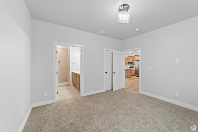 245 E Tidwell Ave Unit 5, Green River, UT 84525 - unfurnished bedroom with light colored carpet, baseboards, stainless steel fridge, and visible vents