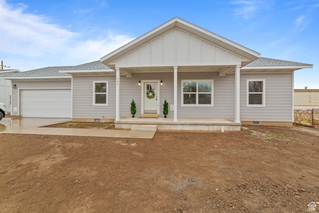 245 E Tidwell Ave Unit 5, Green River, UT 84525 - view of front facade with an attached garage, a porch, crawl space, board and batten siding, and driveway