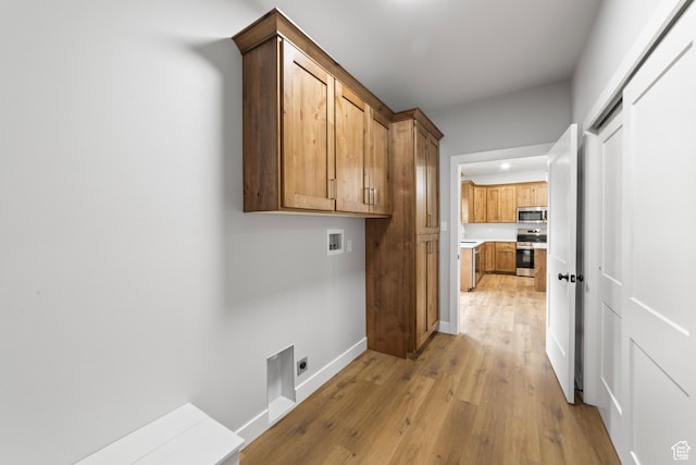 245 E Tidwell Ave Unit 5, Green River, UT 84525 - clothes washing area with hookup for an electric dryer, washer hookup, light wood finished floors, baseboards, and cabinet space