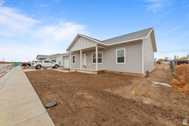 245 E Tidwell Ave Unit 5, Green River, UT 84525 - view of front of home featuring covered porch, crawl space, board and batten siding, fence, and roof with shingles