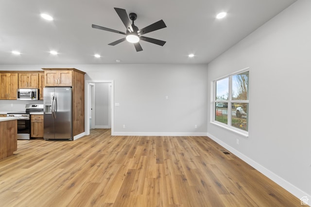 245 E Tidwell Ave Unit 5, Green River, UT 84525 - kitchen featuring open floor plan, light countertops, brown cabinetry, and stainless steel appliances