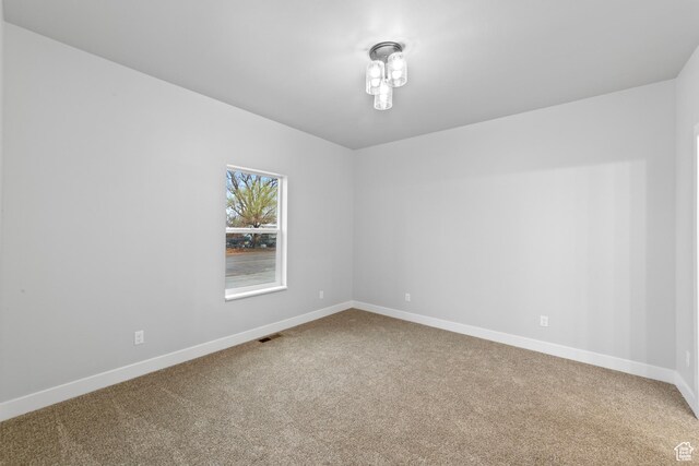245 E Tidwell Ave Unit 5, Green River, UT 84525 - empty room featuring carpet flooring, baseboards, and visible vents