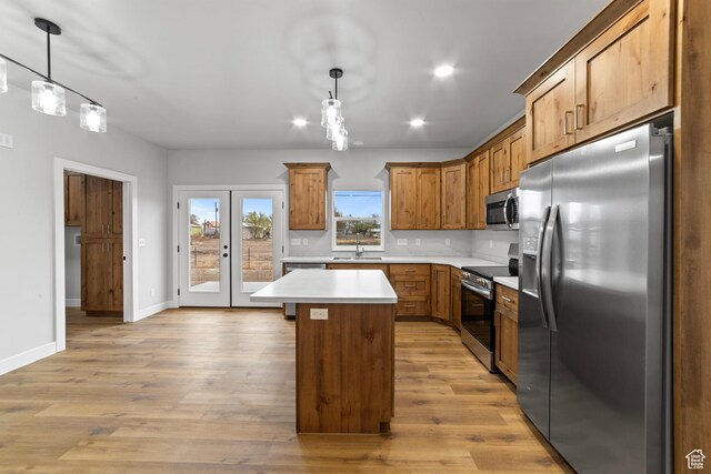 245 E Tidwell Ave Unit 5, Green River, UT 84525 - kitchen with light wood-style flooring, light countertops, a sink, and appliances with stainless steel finishes