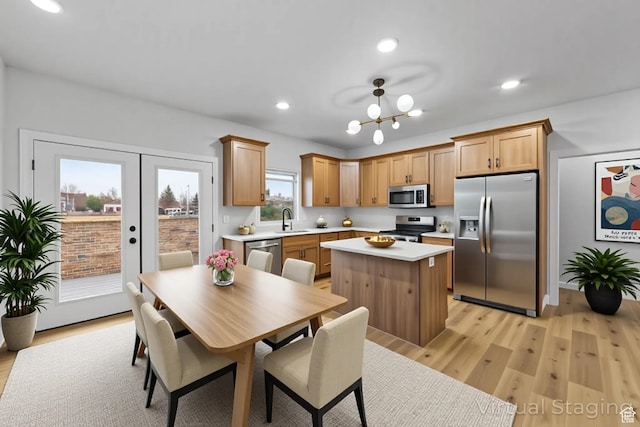 245 E Tidwell Ave Unit 5, Green River, UT 84525 - kitchen featuring a center island, a sink, light countertops, stainless steel appliances, and light wood-style flooring