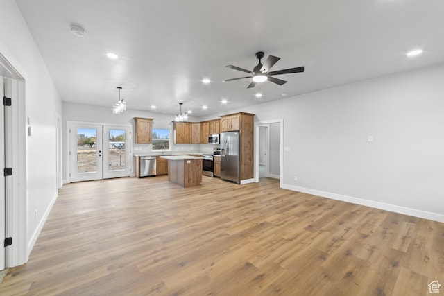 245 E Tidwell Ave Unit 5, Green River, UT 84525 - kitchen featuring light wood-style flooring, a center island, appliances with stainless steel finishes, light countertops, and open floor plan