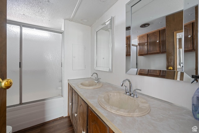 102 N 3910 W, Hurricane, UT 84737 - full bath with double vanity, a sink, bath / shower combo with glass door, and a textured ceiling