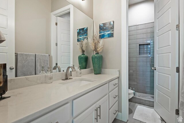 full bathroom featuring a shower stall, toilet, and vanity