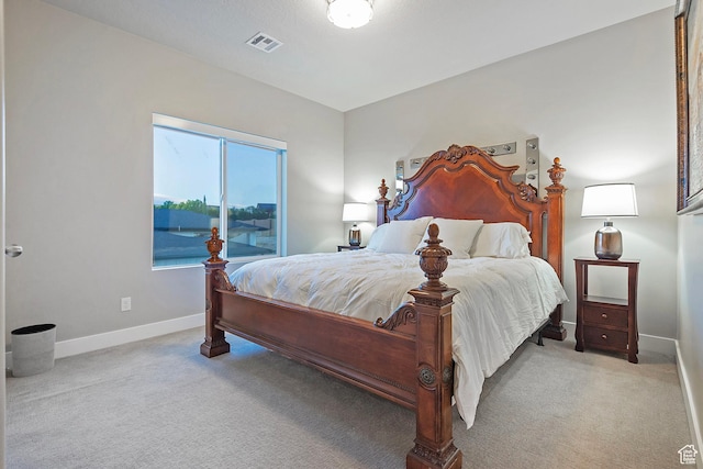 bedroom with light colored carpet, visible vents, and baseboards