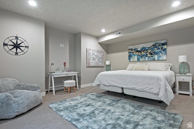 carpeted bedroom with baseboards, a textured ceiling, visible vents, and recessed lighting
