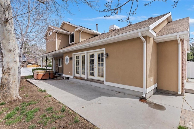 7342 S Promenade Cir E, Cottonwood Heights, UT 84121 - rear view of house featuring a patio area, french doors, a chimney, stucco siding, and a hot tub