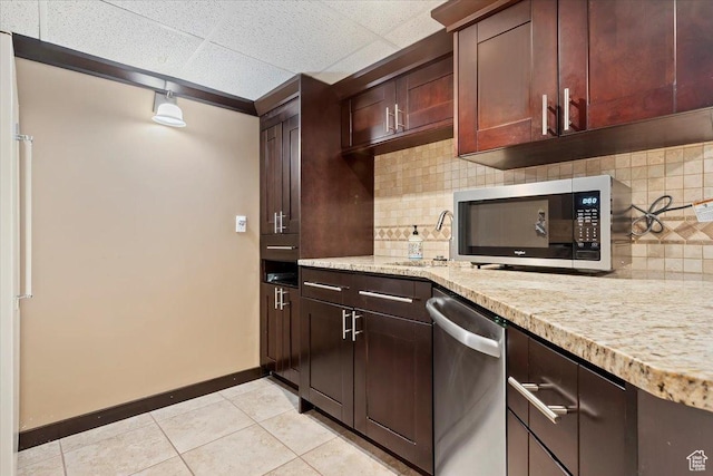 7342 S Promenade Cir E, Cottonwood Heights, UT 84121 - kitchen featuring light tile patterned floors, stainless steel appliances, baseboards, decorative backsplash, and a sink