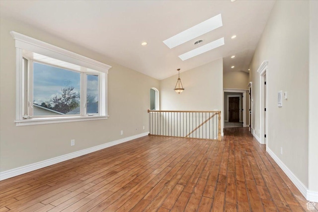 7342 S Promenade Cir E, Cottonwood Heights, UT 84121 - empty room featuring lofted ceiling with skylight, recessed lighting, baseboards, and wood finished floors