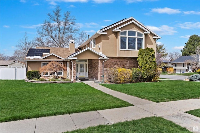 view of front facade with stucco siding, a chimney, fence, and a front lawn