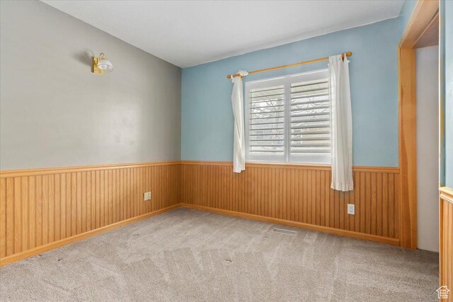 7342 S Promenade Cir E, Cottonwood Heights, UT 84121 - carpeted empty room featuring a wainscoted wall and wood walls