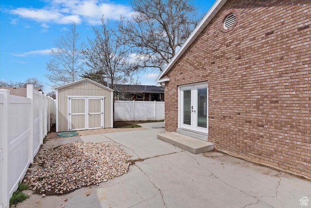 7342 S Promenade Cir E, Cottonwood Heights, UT 84121 - view of patio / terrace with french doors, a fenced backyard, an outbuilding, and a storage unit