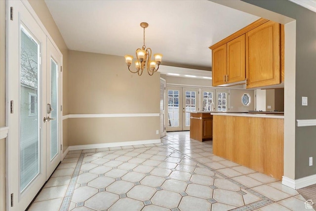 7342 S Promenade Cir E, Cottonwood Heights, UT 84121 - kitchen featuring a notable chandelier, light countertops, french doors, a peninsula, and baseboards