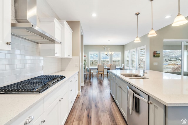 680 S Appenzell Ln, Midway, UT 84049 - kitchen featuring wall chimney exhaust hood, decorative backsplash, a sink, appliances with stainless steel finishes, and wood finished floors
