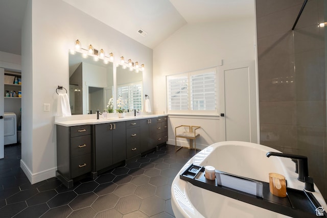 52 N 400 W, Farmington, UT 84025 - bathroom with washer / clothes dryer, a freestanding tub, tile patterned flooring, visible vents, and lofted ceiling