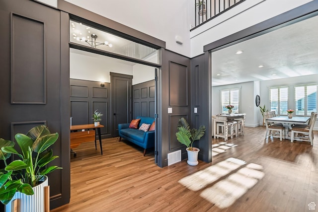 52 N 400 W, Farmington, UT 84025 - interior space featuring light wood-style floors, a decorative wall, and visible vents