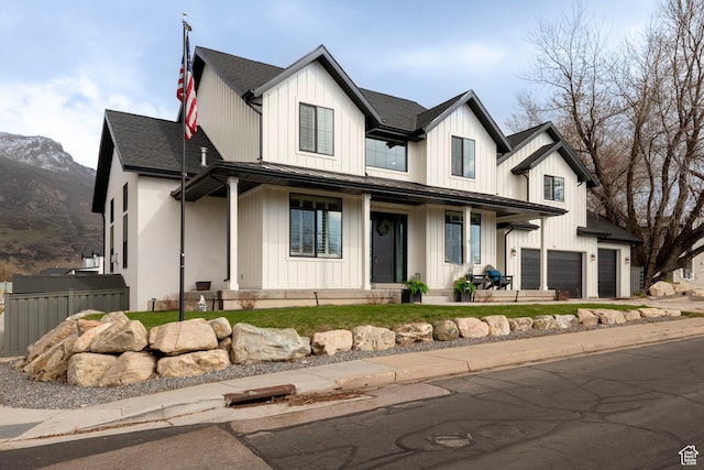 52 N 400 W, Farmington, UT 84025 - modern farmhouse style home with roof with shingles, a mountain view, board and batten siding, an attached garage, and covered porch