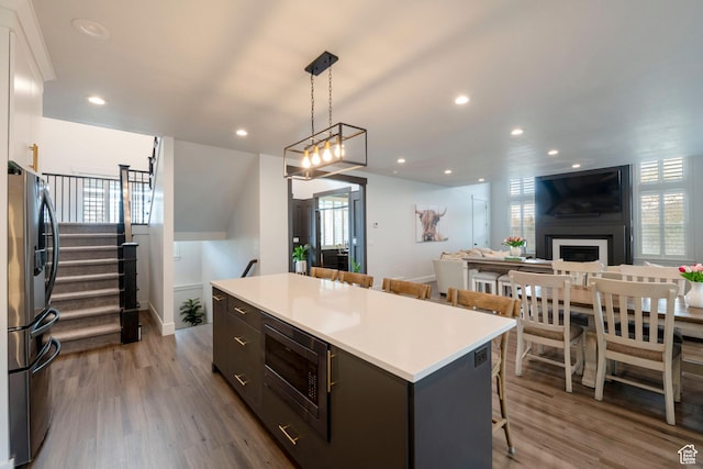 52 N 400 W, Farmington, UT 84025 - kitchen with stainless steel appliances, dark wood-type flooring, a center island, and a breakfast bar area